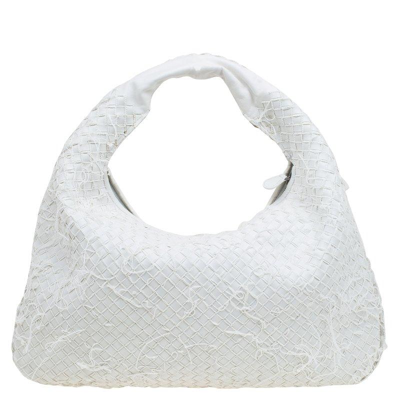 This Bottega Veneta bag is a twist on their classic Intrecciato. With a frayed appearance and the casual slouch hobo shape, this bag is ideal for a relaxed, deconstructed outfit. In crisp white leather, this Veneta bag will complement many different