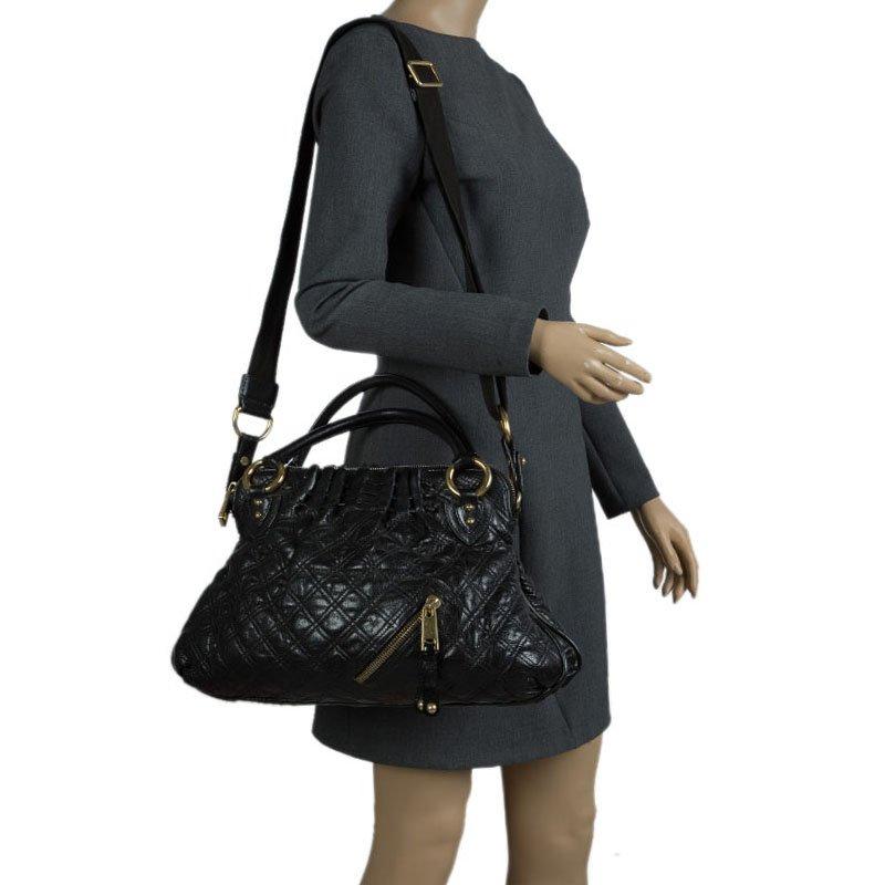 First debuted in 2005, Marc Jacobs ‘Stam’ was named after the beautiful model Jessica Stam. This satchel is crafted from black quilted leather for rich texture and is detailed with a thick brass chain-link shoulder strap, kiss-lock closure and an