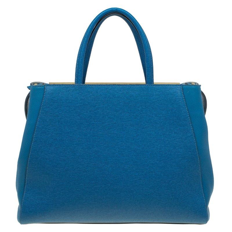 The Fendi for women edit features bold, lavishly created pieces. This handbag pairs playfully striking detailing with traditional and more exuberant shapes. Blue Saffiano leather 2Jours tote from Fendi features round top handles, an adjustable