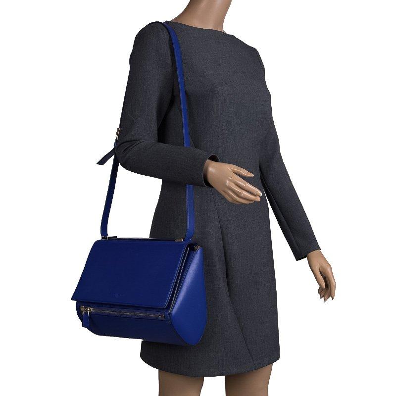 This Givenchy Pandora box bag is crafted in blue leather and features an adjustable shoulder strap. With an eye-catching silhouette and a zipper at the front, the flap opens to a smooth suede-lined interior that offers enough space to hold your