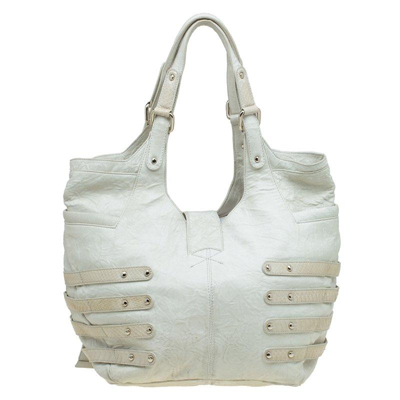 Cream wrinkled large Bree tote bag by Jimmy Choo accented with multiple side straps with buckle details, is a style statement and is hard to miss bag. The dual carry handles makes it comfortable to carry around for an everyday use. The twist-lock
