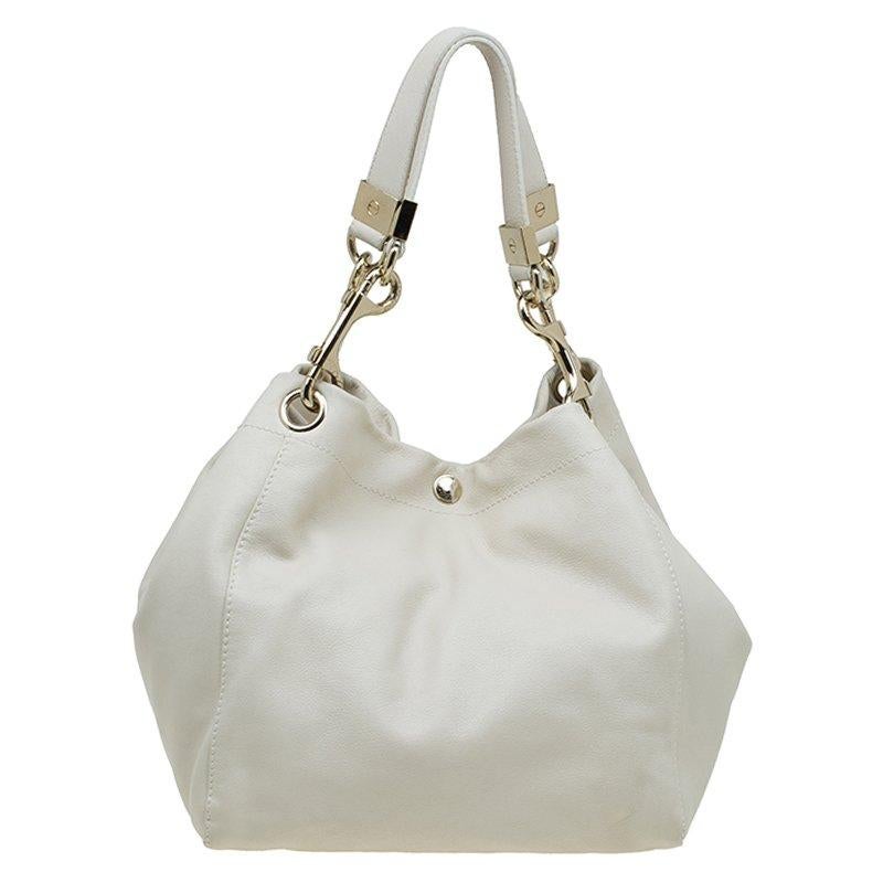 Jimmy Choo Ivory Leather Lohla Jayne tote, is a perfect accessory for the girl who loves to carry around her world with her. This stylish tote with gold-tone hardware looks chic, stylish, effortless and is undeniably practical. The thick flat