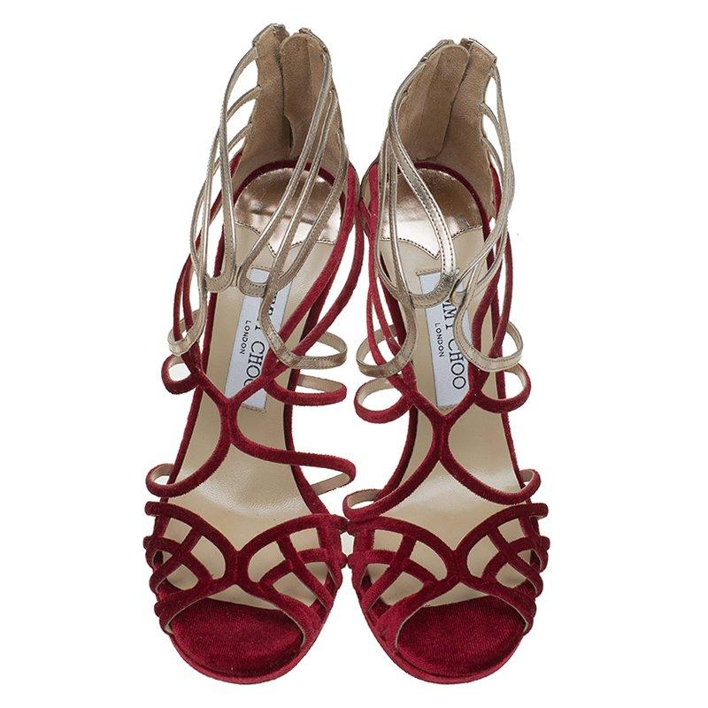 The 'Maury' strappy sandals from Jimmy Choo are the perfect choice for dressed-up vacation nights.  Crafted from red velvet and metallic leather, these open toe sandals feature cut-out straps that frame your foot beautifully. It is finished with