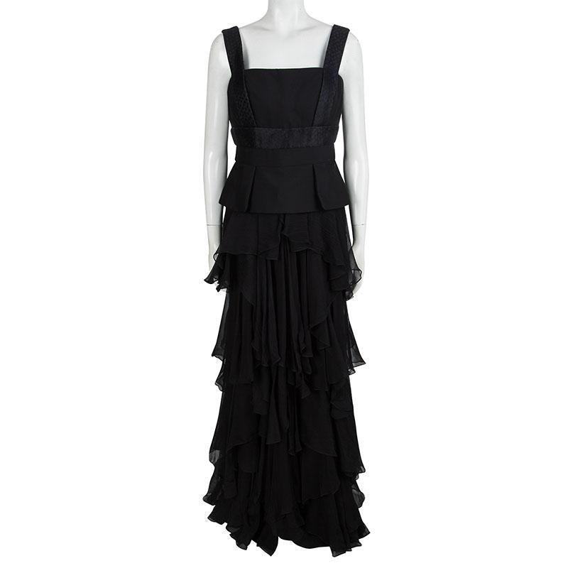 Resplendent and ravishing in black, this peplum gown from Alexander McQueen is sure to set hearts racing. The sleeveless tiered gown is made of a silk and wool blend and features an asymmetrical layered silhouette. It flaunts a square neckline and a