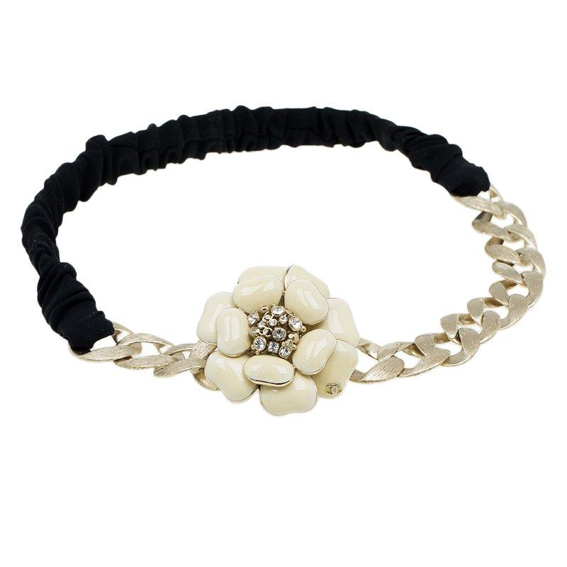 Complete a vintage look with this Chanel headband. Made from gold-tone metal, it features a black band. The flower motif at the top is embellished with crystals.

Includes: The Luxury Closet Packaging

