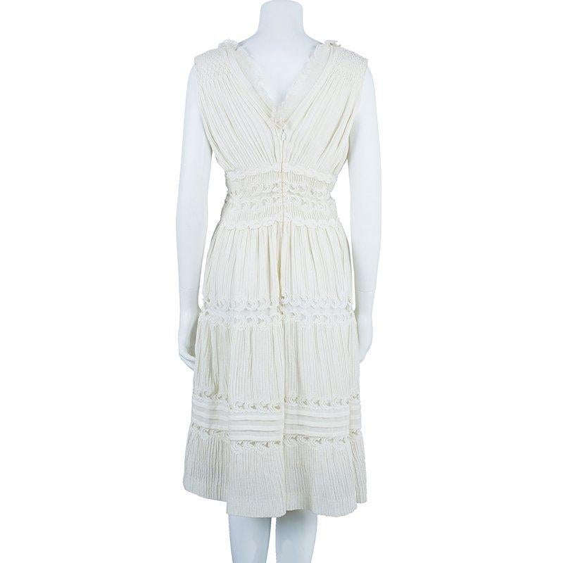 Chloe’s range of day dresses in white are the season’s essential. This alluring offwhite embroidered dress is sure to adorn your silhouette to perfection. The plunge-V shaped neckline on the front and back of this sleeveless dress adds to its