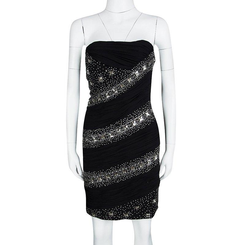 Roberto Cavalli's Ruched dress will have you in awe! The black beauty is made from silk blend fabric and draped to perfection with ruched detailing. The dress is ornate with its placement embroidery and silver-tone sequins work. This LBD deserves a