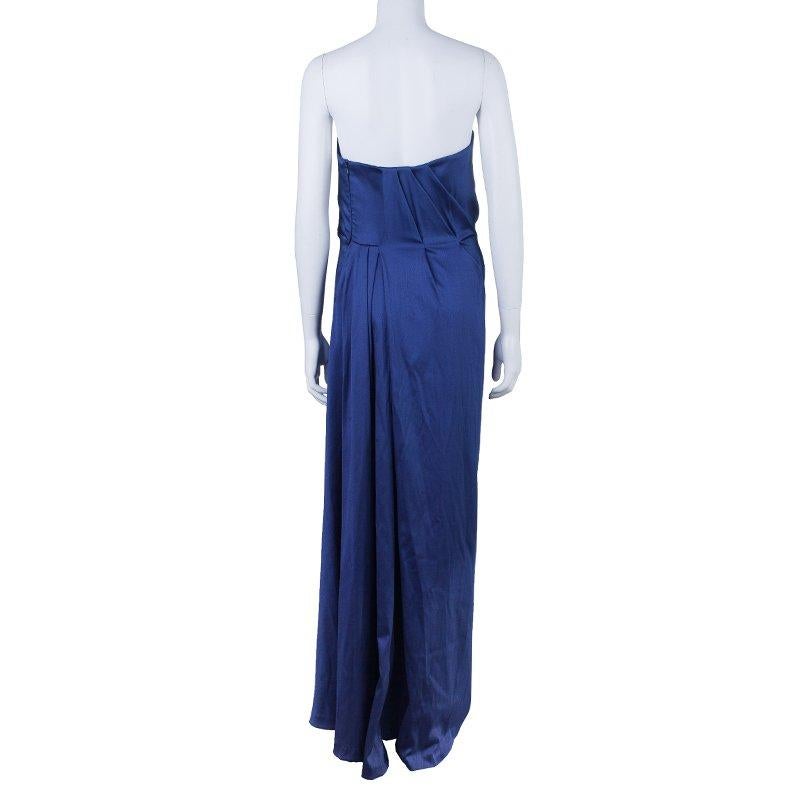 Alberta Ferretti is known to create exclusive designs that exude femininity. Made from an acetate blend, this strapless dress in a fierce blue color is designed with a pleated and gathered waistline and an elegant fishtail gracing the back. Match it