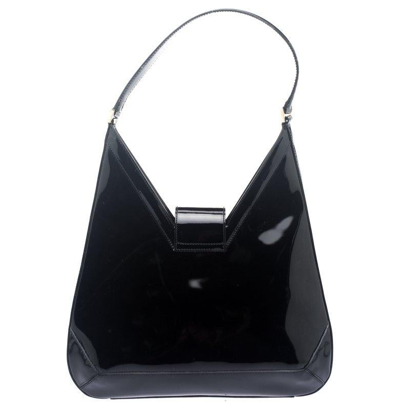 Ideal for everyday use, this shoulder bag is from Salvatore Ferragamo. It has been crafted from patent leather in a black shade and styled with a single shoulder handle. The bag also comes equipped with a spacious suede interior which will house all