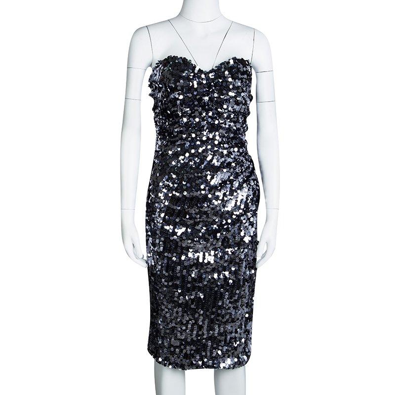 You're all set to dazzle with this dress from Dolce&Gabbana. Decorated with sequins all over, the silver dress carries a strapless style with a back zipper and a hem ending below the knees. It'll look enchanting with a pair of shiny black