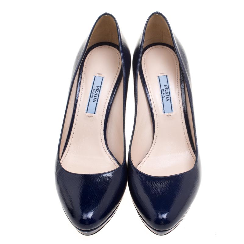 Exude elegance in an effortless way with these pumps by Prada. Crafted from Saffiano leather, they carry a gorgeous blue shade and platforms. The pumps are balanced on 10 cm heels and completed with the brand label on the leather insoles.

Includes: