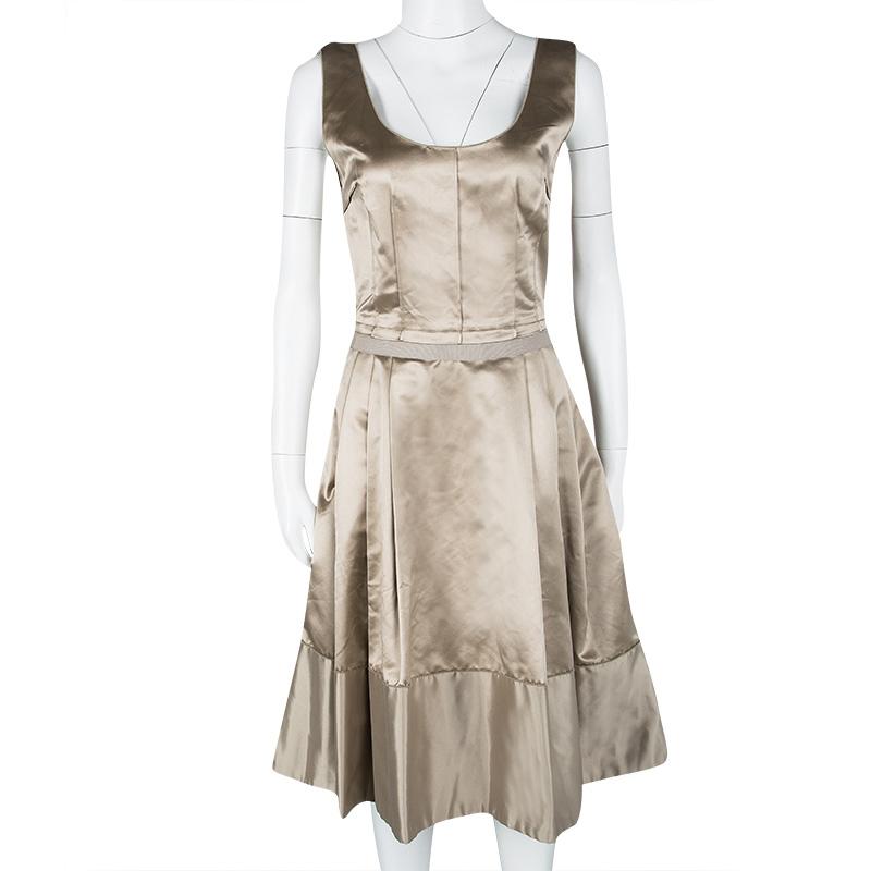 Chic and lovely in appeal, this beige dress is from Dolce&Gabbana. It has been finely cut from silk and styled as a sleeveless with a scoop neck and pleats. It'll look amazing with sparkly pumps.

Includes: The Luxury Closet Packaging


