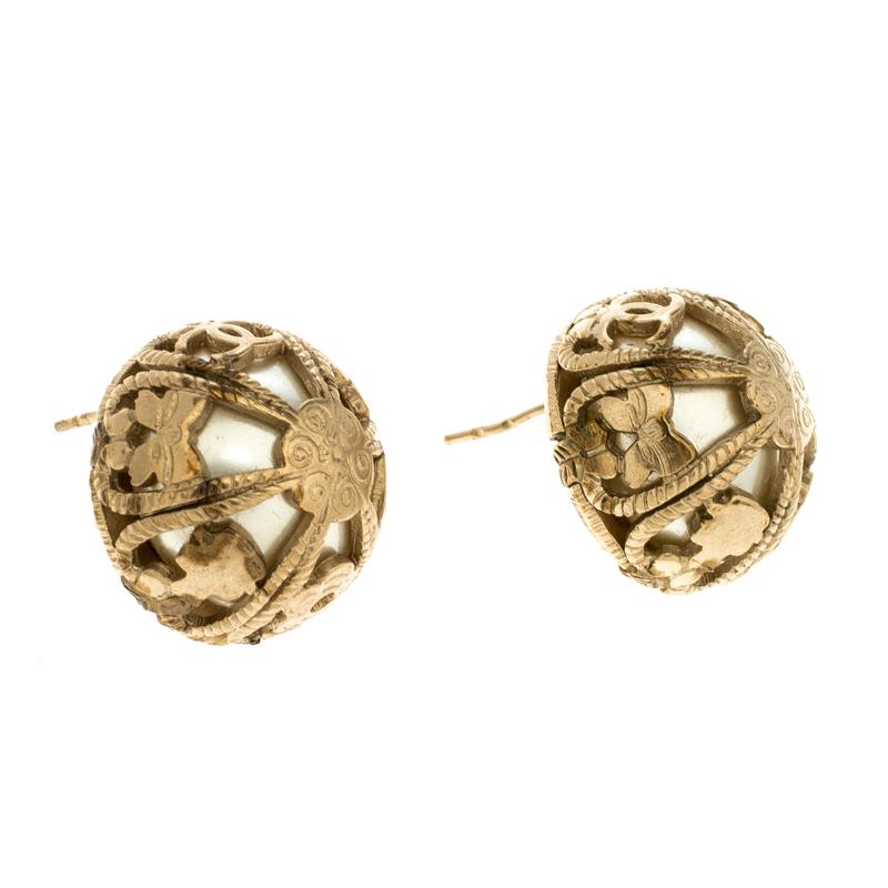 Chanel’s dome stud earrings are graceful and sophisticated. The dome shaped carving is molded over a pearl base. The gold-tone earrings come with a stud back closure and are hassle free style making it easy to wear it for long hours or even as an