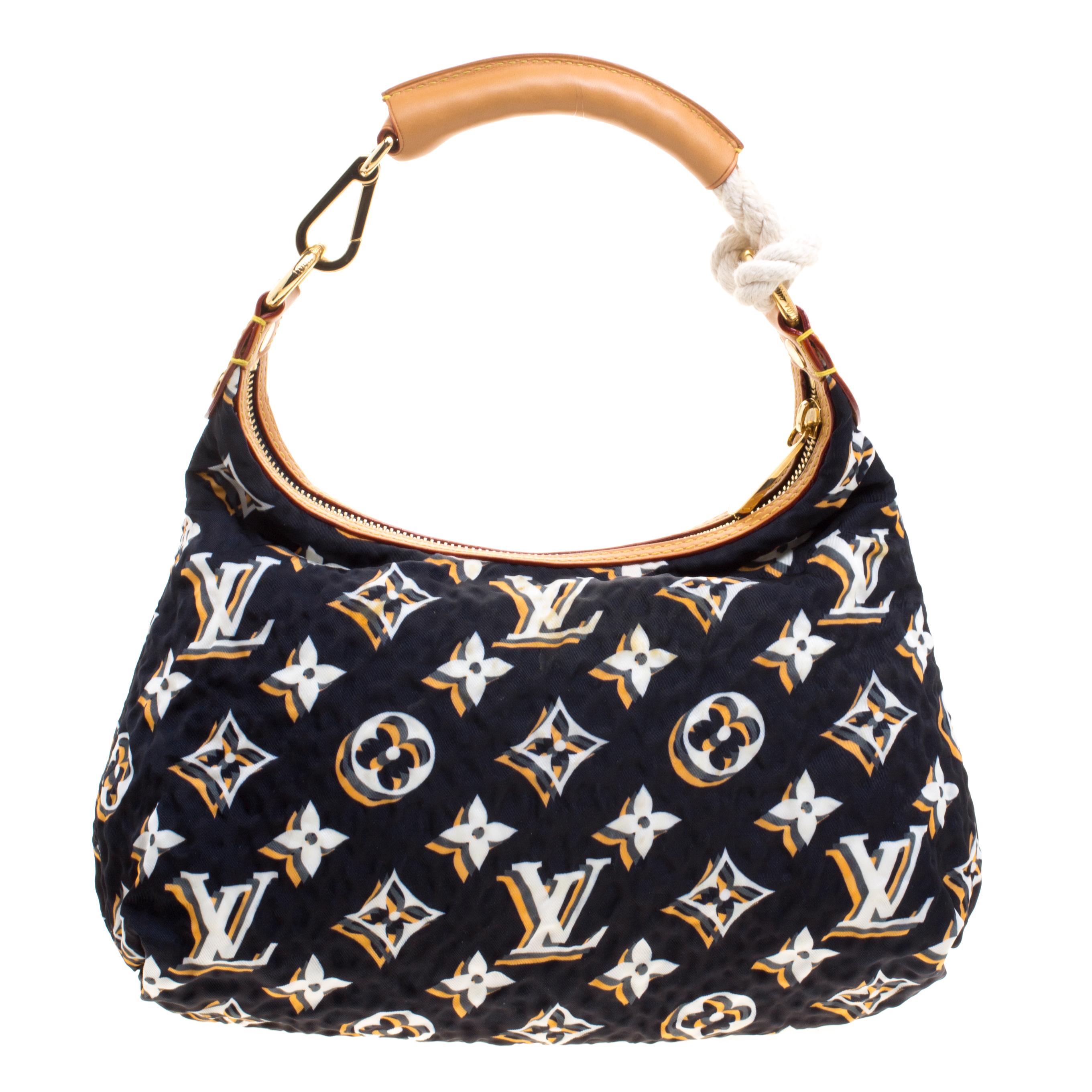 Part of the Limited Edition, this Louis Vuitton bag features a blue monogram fabric body with leather accents. It comes with a rolled top handle and secured with a top zipper closure. Accented with gold-tone hardware, this bag is perfectly