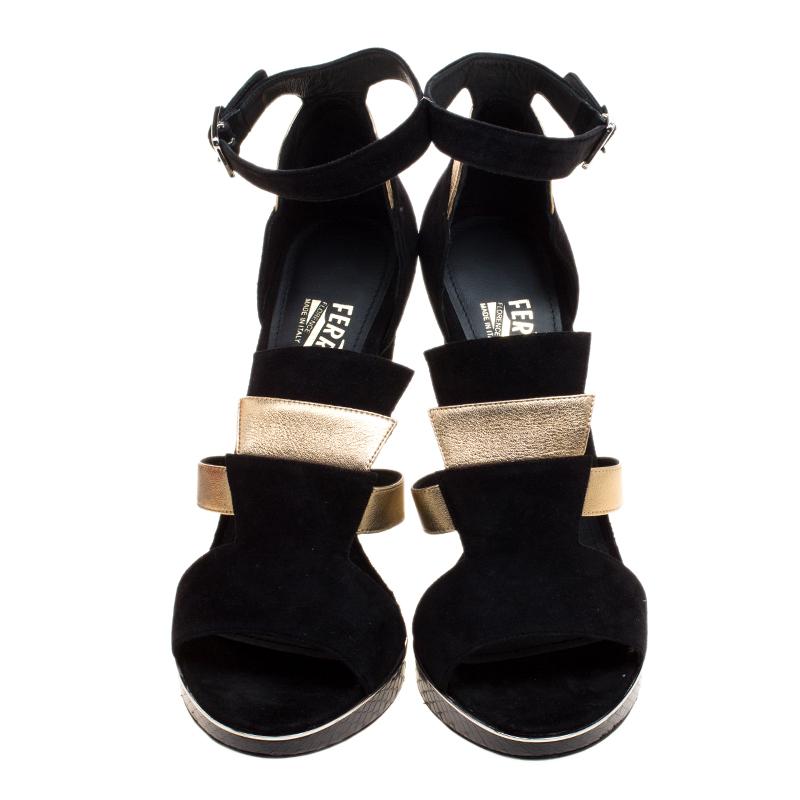 Coming straight out of the Art Deco era, these exquisite Lexus Salvatore Ferragamo sandals are sure to make a statement. They are skillfully created from panels of black suede and gold leather and rests on a structural stacked heel. It comes with a