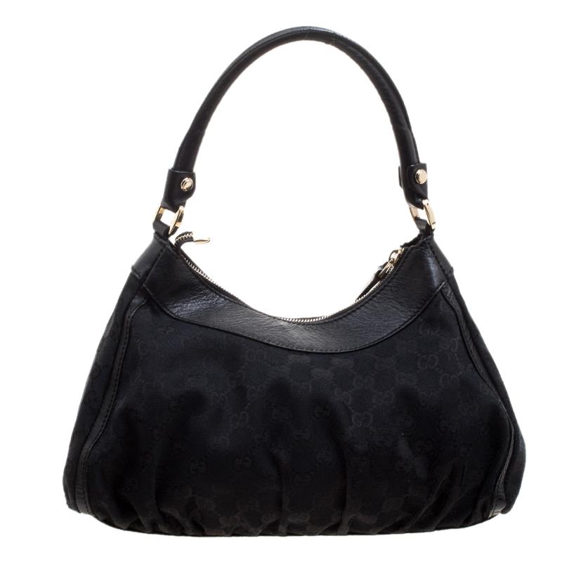 Gucci brings to you this amazing D Ring hobo that is smart and modern. Made in Italy, this black hobo is crafted from classic GG canvas and features a single top handle. The top zipper reveals a fabric lined interior with enough space to hold all