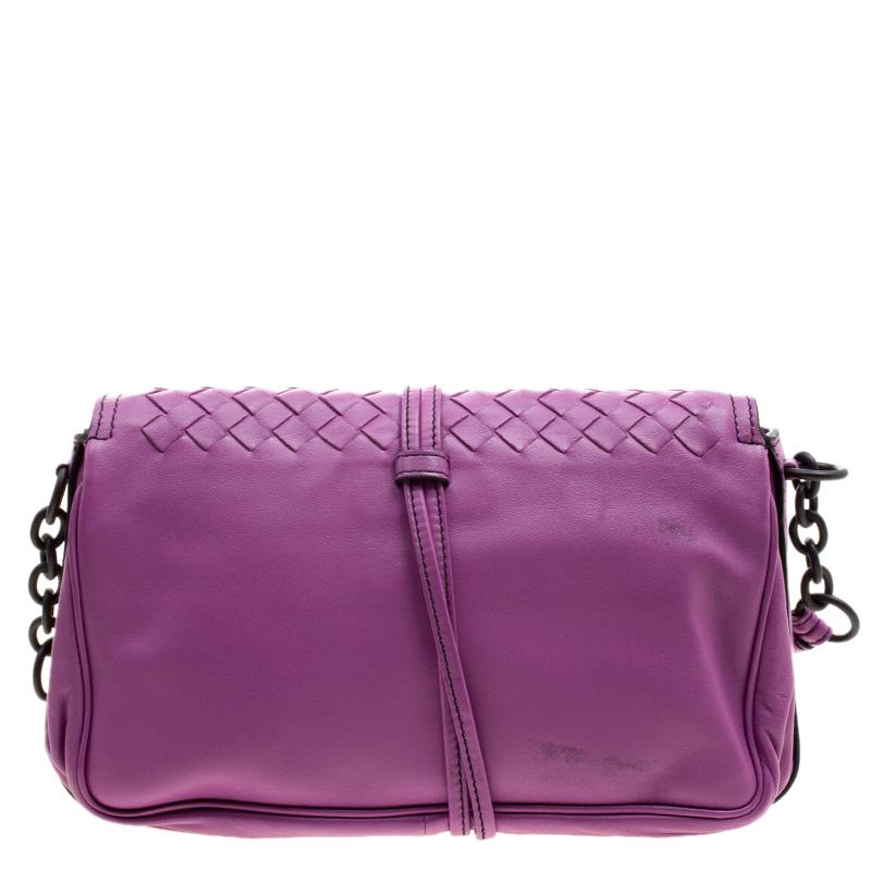 This Crossbody bag from the house of Bottega Veneta is crafted in the label's signature Intrecciato weave pattern in a refreshing purple hue. It features a flap style and detailed with contrast black stitch detailing. Fitted with a shoulder strap,