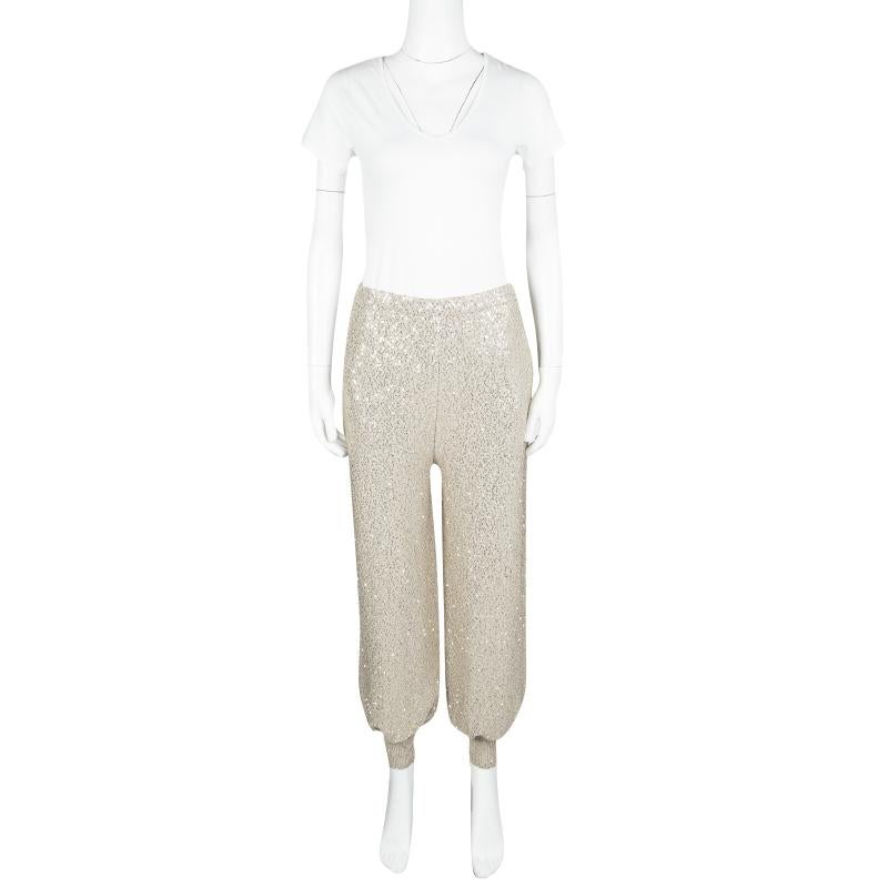 Add bling to your comfort with the Oscar de la Renta Beige Sequined High Waist Jogger Pants. These jogging pants with sequins all over have an elaticised waist and elasticised ribbed cuffs. The legs are relaxed, providing the comfort of jogging