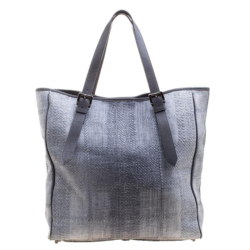 When you carry this Burberry creation, be ready to catch admiring glances as this tote is stylish and handy. The bag has been crafted from raffia in a gorgeous grey shade. It is equipped with two leather handles, and a very spacious nylon