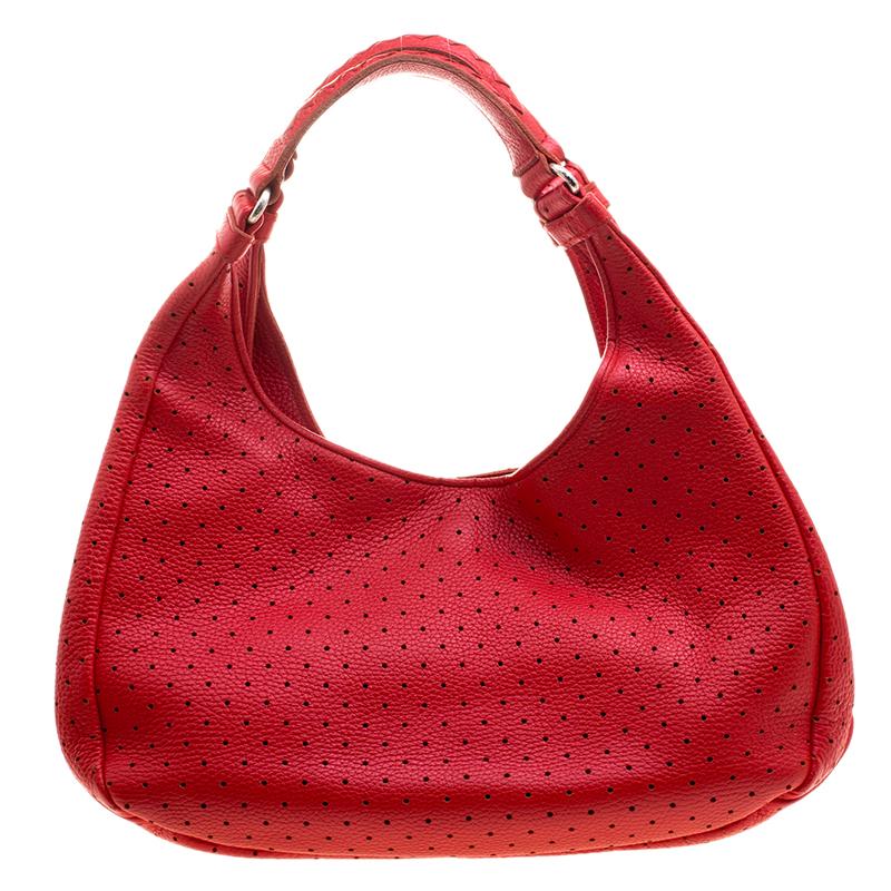 Simple and in style, this hobo from Bottega Veneta definitely needs to be in your closet. The red hobo is crafted from perforated leather and spells creative excellence. It features a single handle and a spacious interior that will hold all your