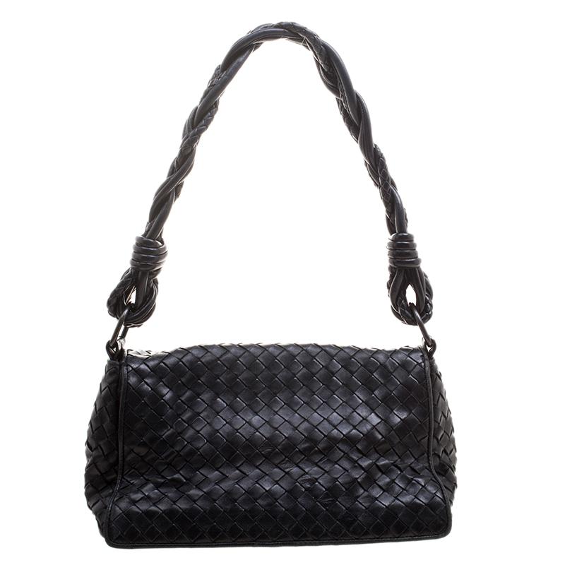 Bottega Veneta brings us this gorgeous shoulder bag that has been crafted from leather in their signature Intrecciato pattern and designed with a flap that opens up to a suede interior capable of carrying your essentials. The piece is complete with