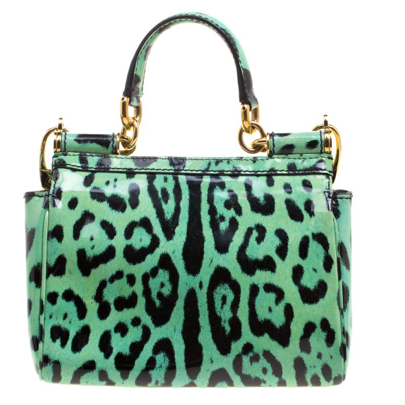 Designed as a day to night wear bag, and in a statement leopard print, this Dolce and Gabbana small Miss Sicily tote is stylish and bold. Crafted in green leopard printed patent leather, this bag os adorned with gold tone hardware details, a top