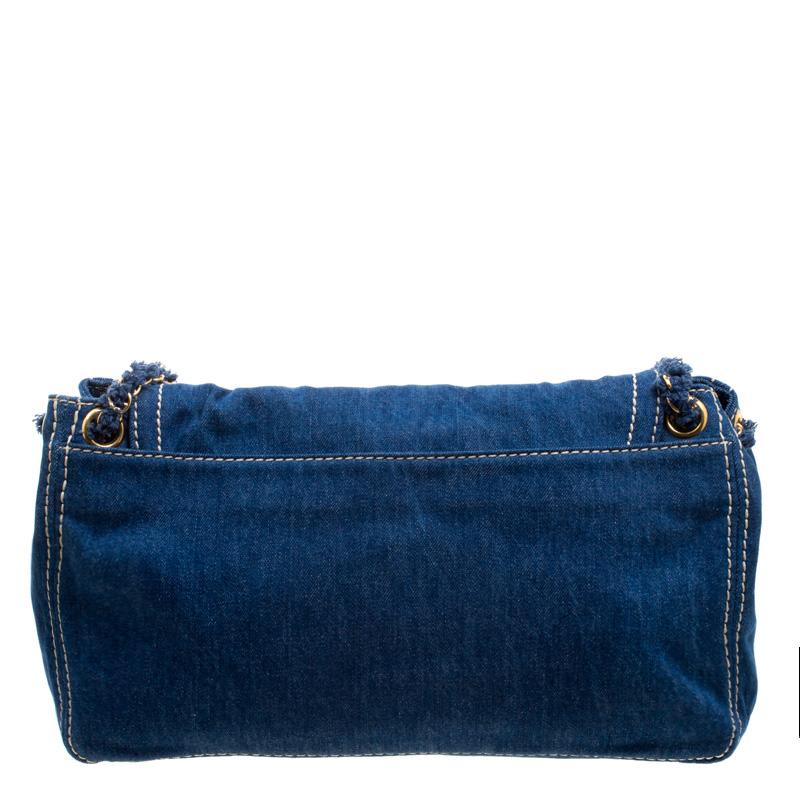 Prada brings us this gorgeous shoulder bag that has been crafted from denim and designed with a flap that opens up to a canvas interior capable of carrying your essentials. The piece is complete with shoulder chain handles and the brand label
