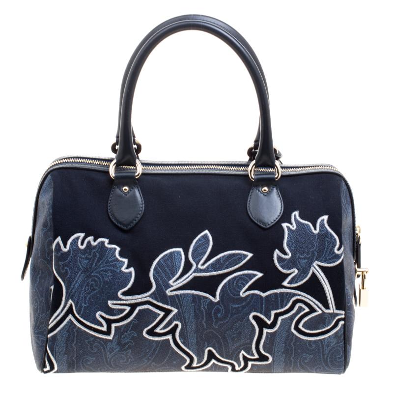 Feminine and functional, this Etro satchel is masterfully crafted in a navy-blue coated canvas and canvas body and detailed with paisley embroidery on the front body. It features two rolled top handles and secured with a zipper closure. It also
