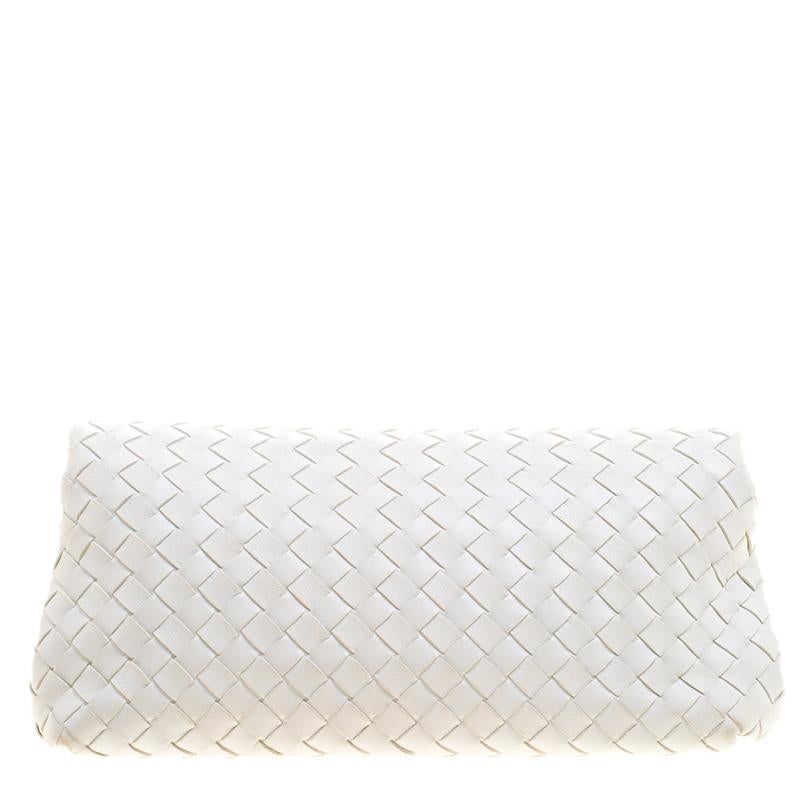 This gorgeous clutch from Bottega Veneta is crafted from white leather and has the signature intrecciato pattern all over it. The flap opens to a suede lined interior that can hold all your necessities. Carry this on all your fashionable