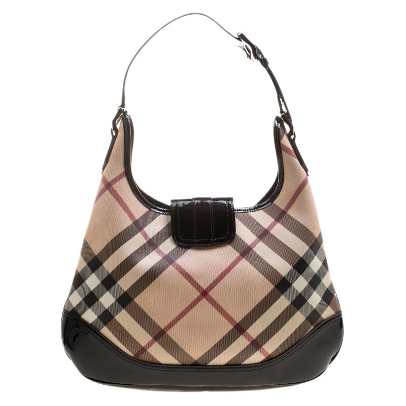 Step out in style with this version of Brooke hobo from the British luxury fashion house of Burberry. Designed in classic nova check PVC the bag features a single handle and a front flap closure. It has a roomy fabric lined interior that houses a