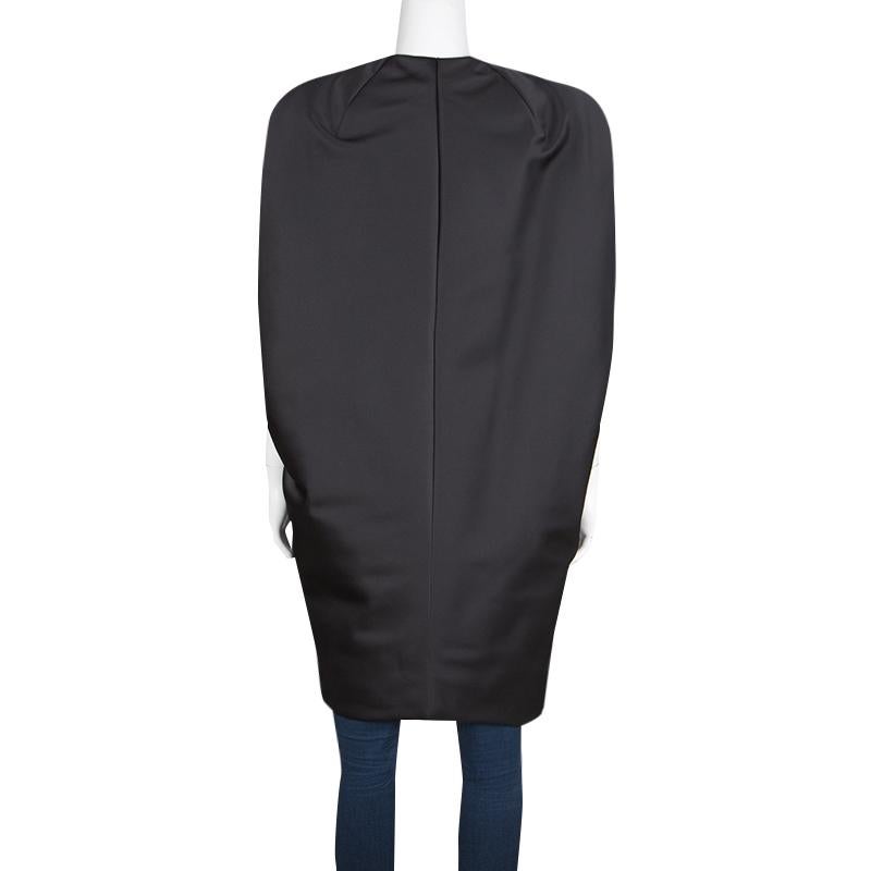 A unique and fashion forward long jacket from the fashion house of Balenciaga, this gilet will instantly get your glam ready. Constructed in a classic black colour, this jacket features a concealed zipper down the front along with a dramatic lapel