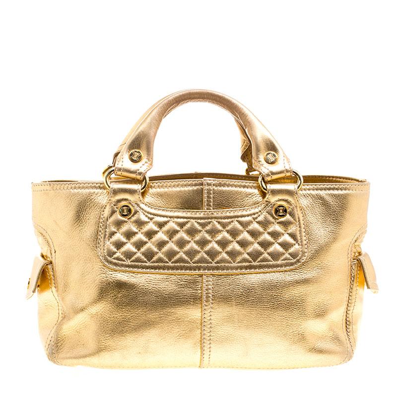 A spacious handbag with the style and glam of an evening bag, this Celine Boogie tote is perfect to add to your regular outfits for an instant shine and glamour. Crafted in gold leather, this bag features quilted panel at the front and back