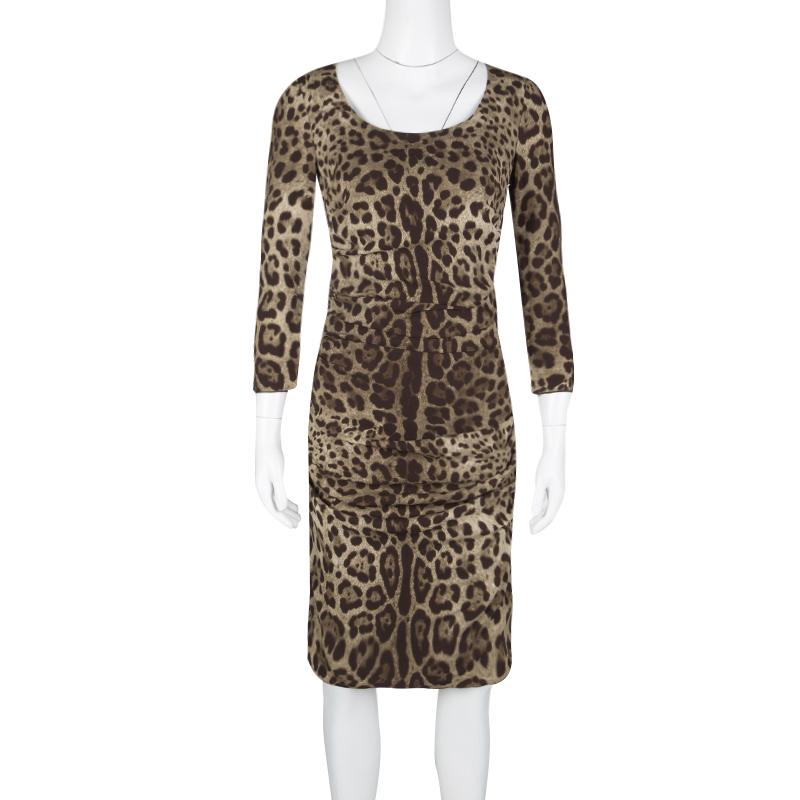 Give yourself an extremely chic look in a party by adorning this Dolce and Gabbana body-hugging knee length dress. It is artfully crafted in an animal print and has a ruched pattern to give you the freedom of moving around easily. This one-piece