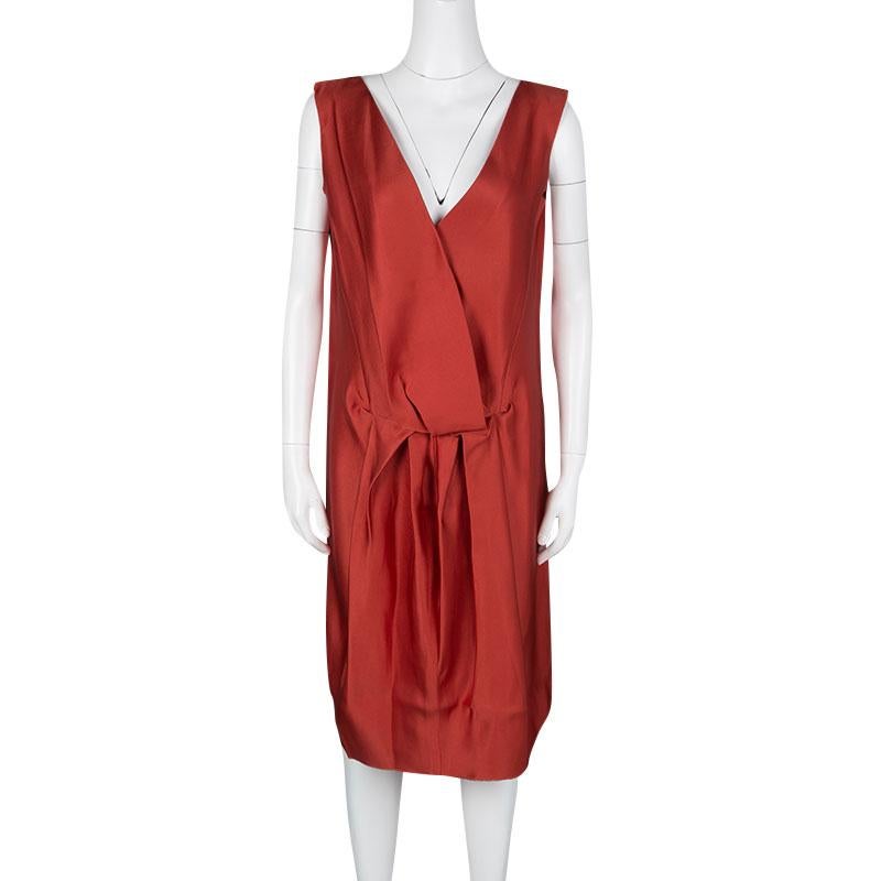 Go bold with this bright red dress by Lanvin. Crafted in a gorgeous silk material, this dress features a drop waist straight fit with a deep V neckline. The front is designed with a drape detailing in layers making this the perfect depiction of your