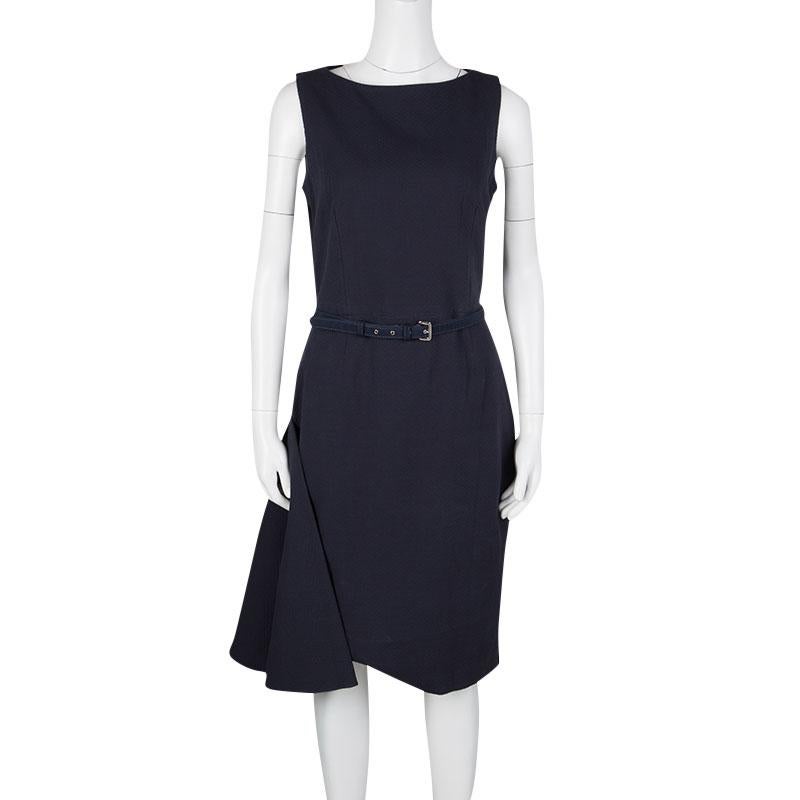 Monochrome always makes a bold statement when it comes to eveningwear. This navy blue sleeveless dress by Dior is a stunning fashion choice with its boat neck and belt detail accentuating the silhouette at the waist. The dress also features a