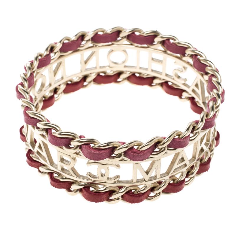 Wear your style in a chic fashion with this Chanel bracelet that comes in a trendy gold tone design. Craved into a chic leather interlocking design, this bracelet that says, 'Make Fashion Not War' is a great way to make a trendsetting statement that