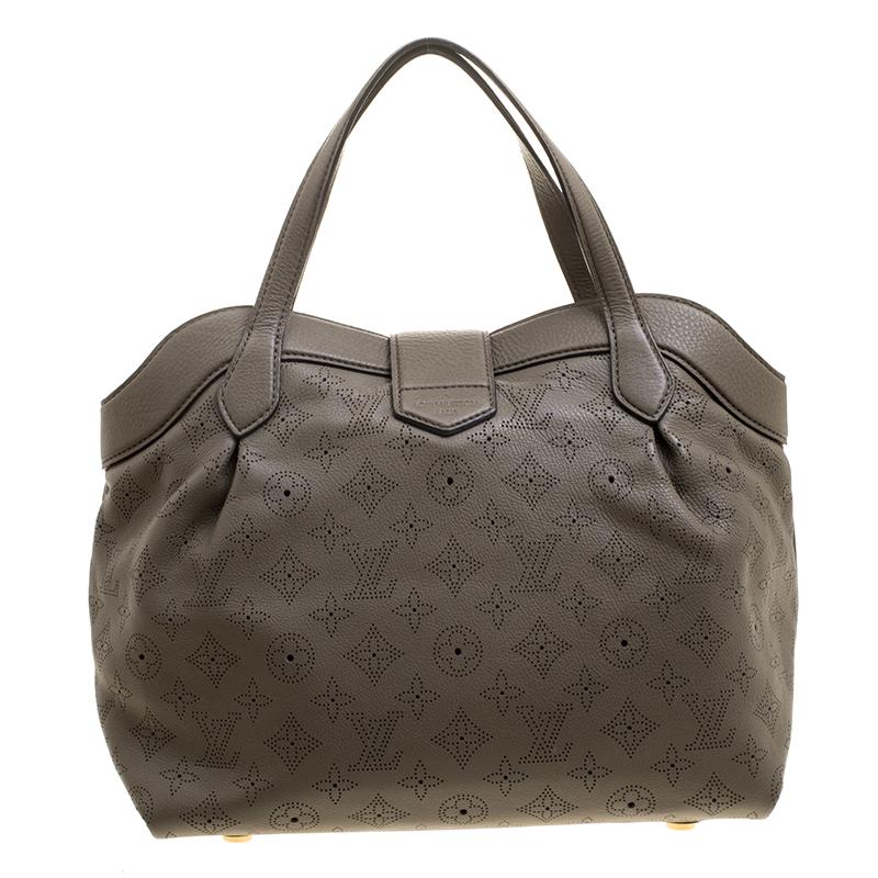 Louis Vuitton's Mahina collection was inspired by the crescents of the moon. This Cirrus bag comes in a lovely taupe color and is crafted from perforated Monogram Mahina leather. The push lock closure opens to an Alcantara lined interior that will