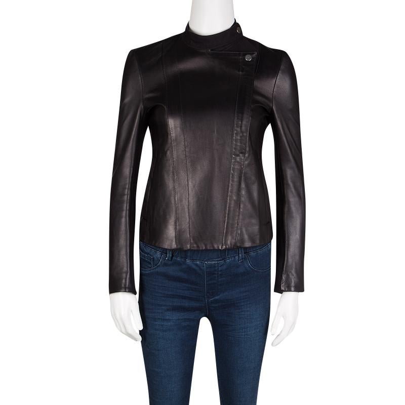 Feel like a fashion diva when you wear this jacket from The Row. The black creation is finely tailored from lambskin leather and designed with pockets, zippers and snap buttons. You'll look fabulous when you assemble this creation with dresses and