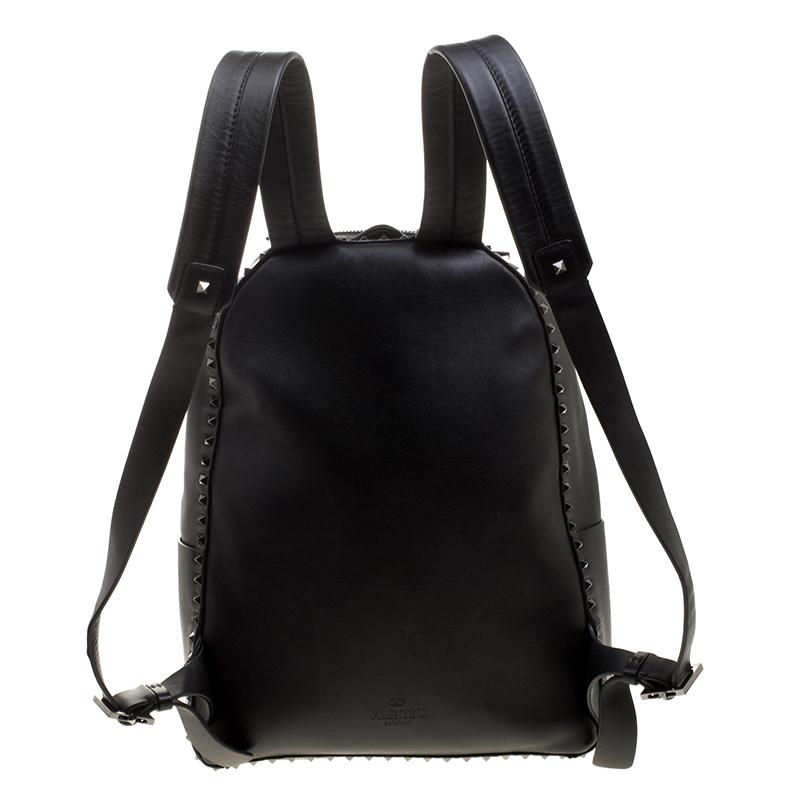 This backpack from Valentino is meant for on-the-go, modern women. Designed in black leather, it flaunts the signature rockstud style of the brand. The fabric-lined interior has large storage space. It also features a zipped pocket on the front and