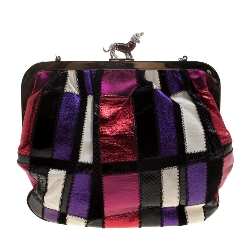 Invest in this statement accessory from Dolce and Gabbana! This clutch is crafted with a blend of exotic leather and underlines a shiny multi-coloured patchwork on the exterior. The most attractive feature is the crystal embellished dog on the lock