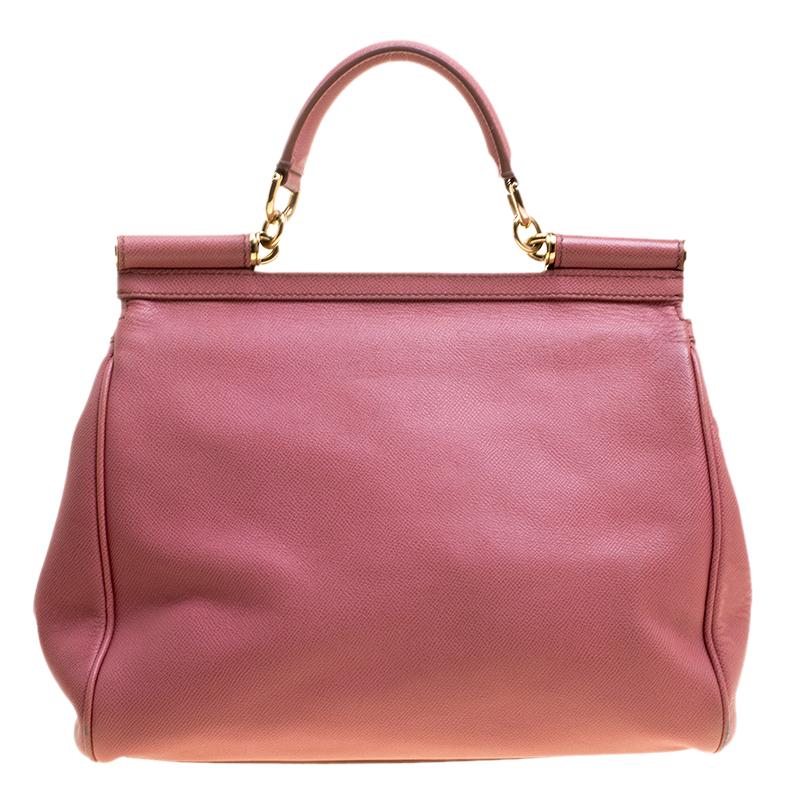 The Miss Sicily tote is one of the most celebrated creations from Dolce and Gabbana. The tote beautifully embodies the spirit of extravagance and feminity that the Italian luxury brand carries. Crafted from pink leather the tote has a structured