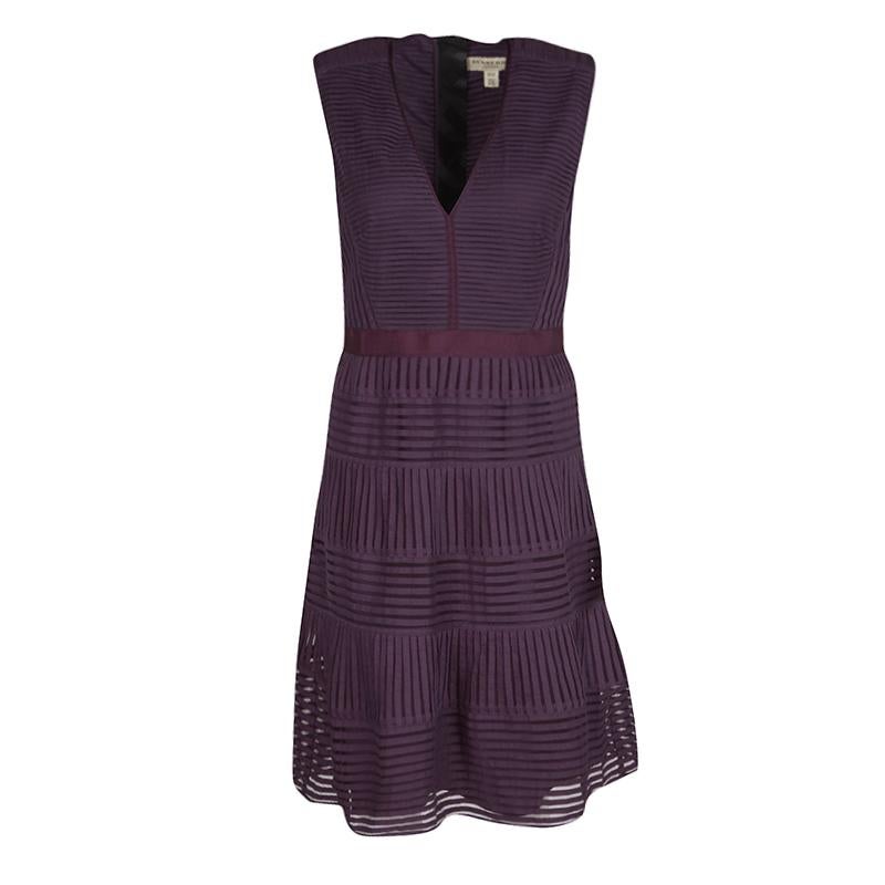 Upcoming garden party or outdoor brunch? Dress up in this Burberry dress featuring an A-line silhouette. This sleeveless style is designed in a gorgeous shade of purple with shadow striped pattern and boasts of a V-neckline. Complete the look with a