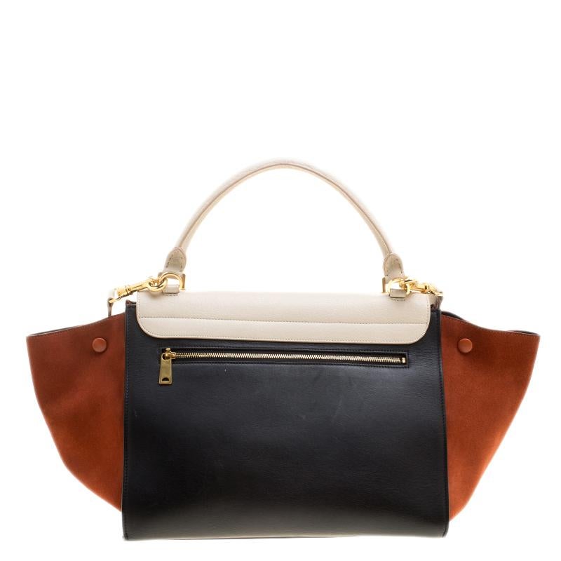 You feel amazing when you look amazing! Made from leather and designed with suede flappy wings and a spacious leather interior, this Celine tote is a classic piece to add to your collection. You can use the top handle or the shoulder strap and be