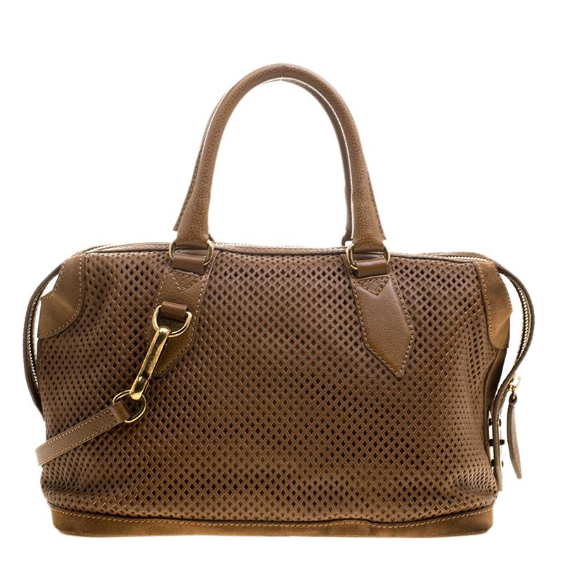 This gorgeous Gilmore satchel is by Burberry. It has been crafted from perforated leather and equipped with a shoulder strap, two handles and a top zipper that leads to a spacious canvas interior capable of holding all your items. This satchel is