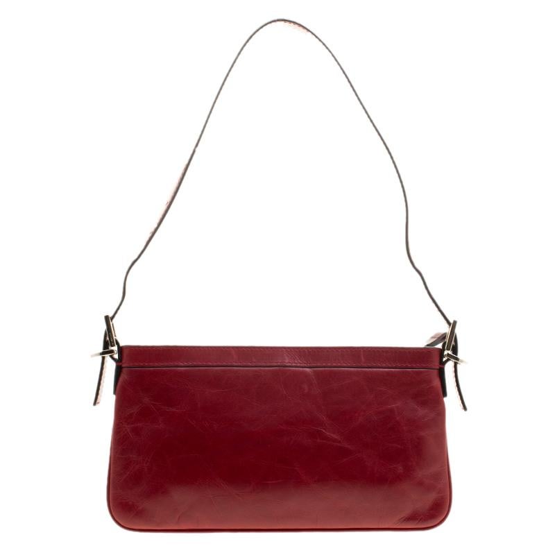 The embossed Givenchy logo in silver-tone hardware on the front is the highlight of this petite shoulder bag. Everything from it's lovely red hue to the smooth leather, makes this bag worth the splurge. The interior is lined with nylon. A single
