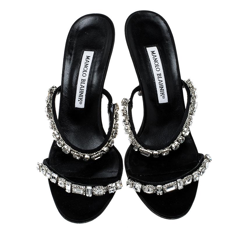 These beautiful and glamorous Manolo Blahnik sandals are a perfect addition to your special occasion wear collection for both the day and night time. Constructed in black suede and black leather lined material, these sandals are made special with