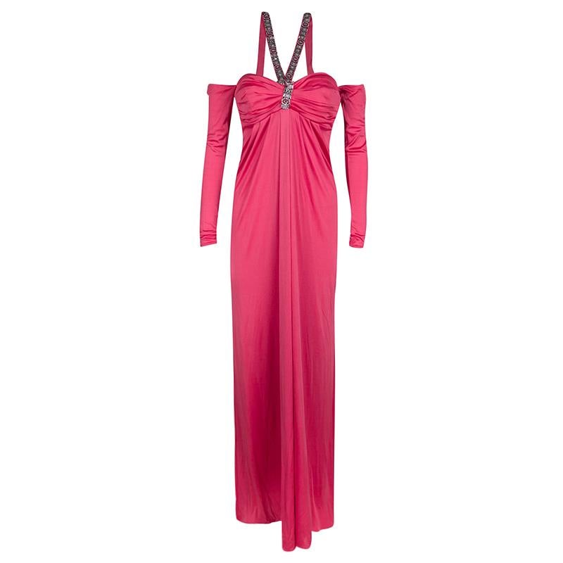 Brimming with feminine details, this Blumarine off-shoulder maxi dress will make you feel no less than a diva. The outfit features a lovely pink hue, slightly ruched bodice, and embellished shoulder straps. It is completed with long sleeves, wear