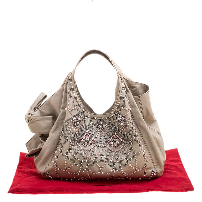 This hobo from Valentino will make the dream of countless women come true. Crafted from leather, this bag has beads, faux pearls and crystals breathtakingly adorned on the front. While the embellishments elevate its beauty, the satin-lined interior