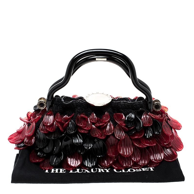 We cannot figure out whether this Bvlgari bag is more well-crafted than stylish. But what we do know is that this bag makes our hearts flutter. It is brimming with fun details like the glass petals all over the exterior, the two wavy handles, and