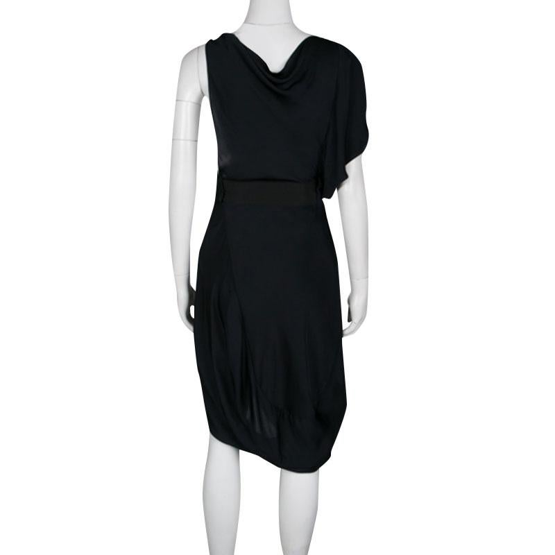 Celine is known for their classic collection of unique aesthetic and modern designs. This sleeveless dress is for the confident, modern women who love flaunting a bold style. Cut in a layered design; this navy blue outfit features a slightly draped